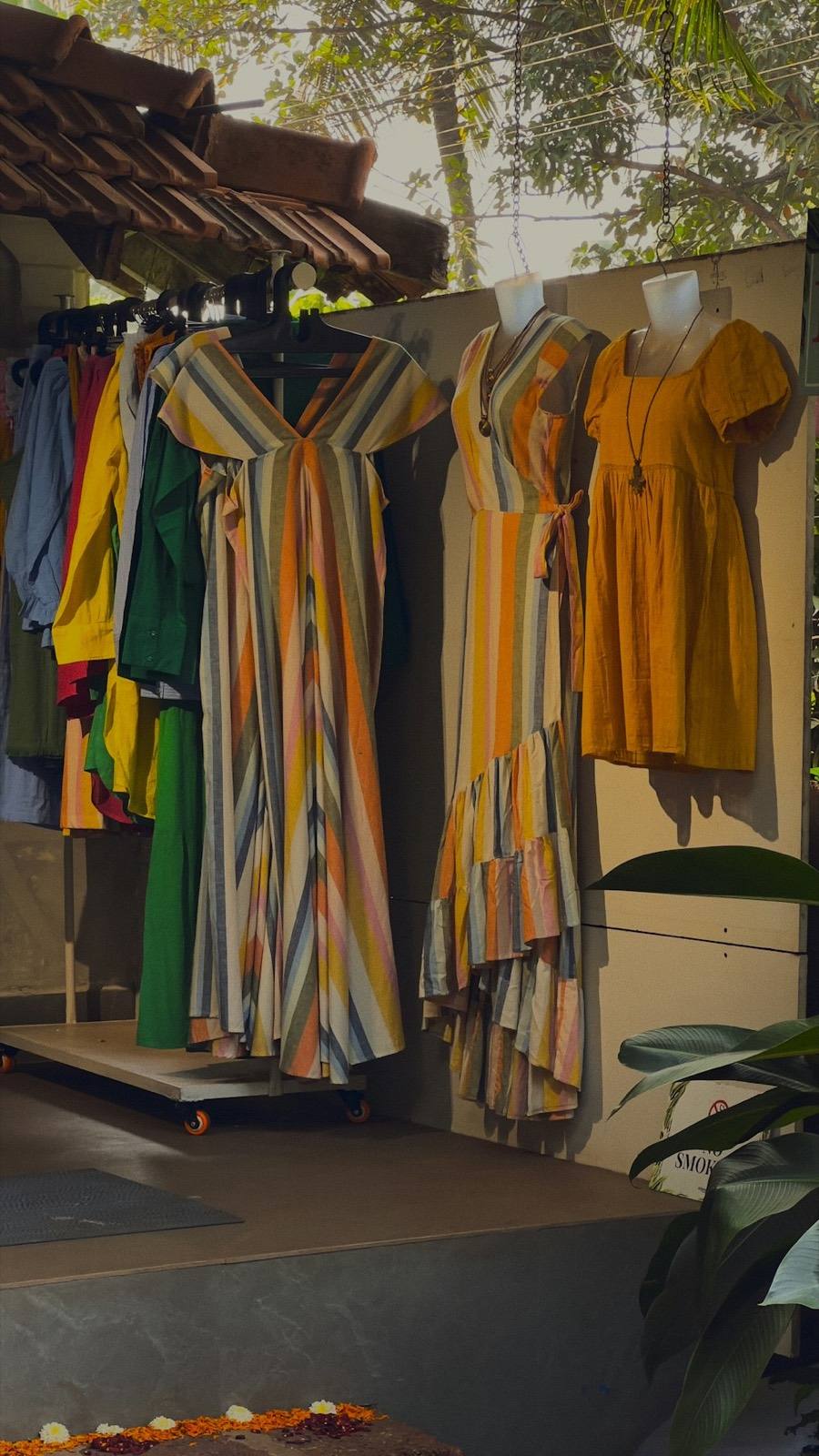Fashion boutique owner holding clothes