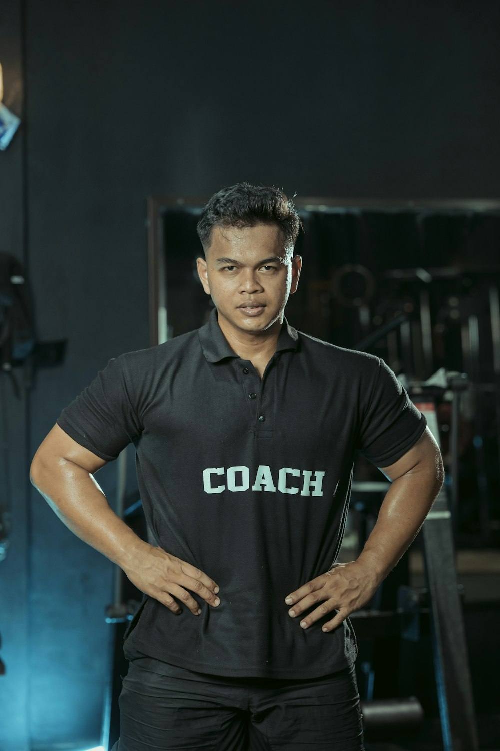 Gym coach posing with hands on hips